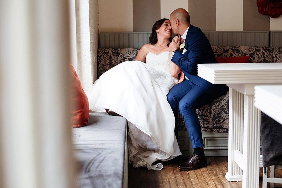 Portrait of bride and groom kissing