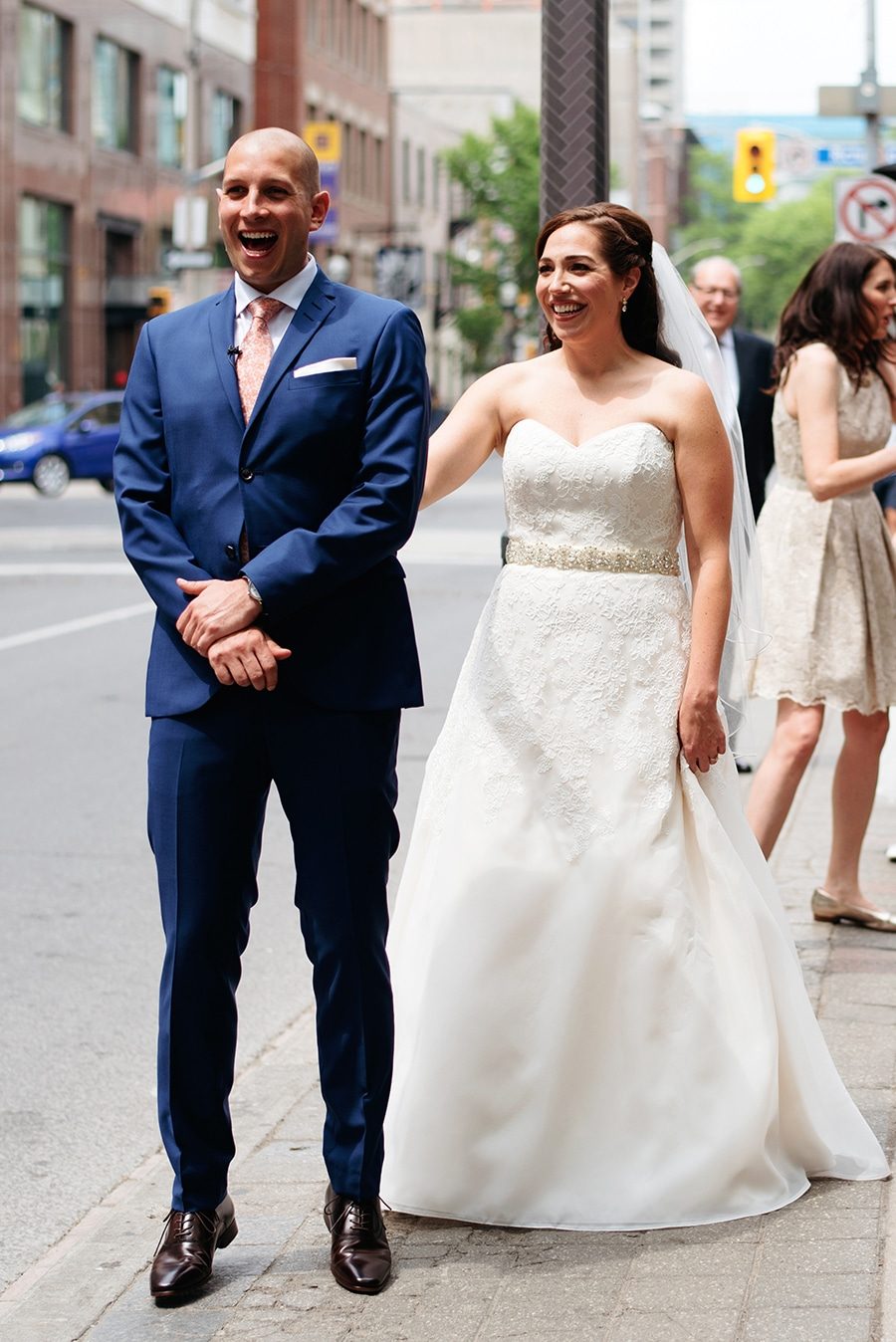Bride tapping her groom on the shoulder